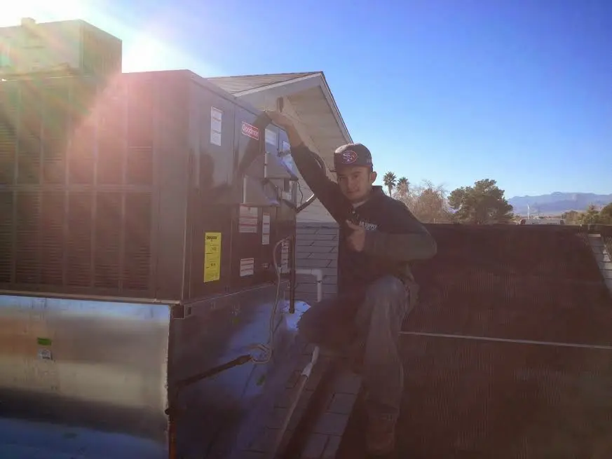 HVAC technician performing HVAC Inspection on a rooftop unit in Worthington